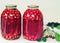 Home canning: large glass cylinders with cherry compote.