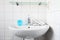 Home care image bathroom washbaisn ,tab water with a bottle blue gel alcohol sanitizers for washing hand and hand towel for