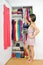 Home closet - woman choosing her fashion clothing