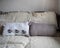 Home comfort, hand-knitted cushions on pillows on a sofa covered