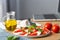 Home cooking concept. Caprese salad. Italian famous salad with fresh tomatoes, mozzarella cheese