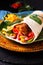 Home cooking concept Organic Homemade Fried chicken burrito tortilla sandwich on color plate and black copy space