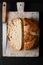 Home Cooking Homemade Organic Sourdough bread on black background with copy space