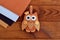 Home decor cute toy on wooden background. Felt owl sewing pattern