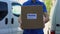 Home delivery service courier in uniform holding cardboard box, express shipping