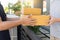 Home delivery service delivers package at home and woman receiving by signing for online shopping order
