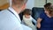 Home doctor came to sick boy and his mother. he examines a child and records readings in notebook