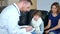 Home doctor came to sick boy and his mother. he examines a child and records readings in notebook