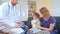 Home doctor came to sick boy and his mother. he examines a child and records readings in notebook