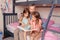 Home education homeschooling. Dad reading book to daughters girls in a bedroom. Family father and children at home spending time