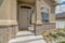 Home entrance with steps white front door sidelight arched windows and yard