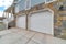 Home exterior with two car attached garage and stairs going up to the entrance