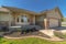 Home facade with bay window concrete porch landscaped yard and gabled garage