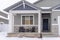 Home facade with gable roof front porch and door with wreath in winter