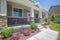 Home facade with plants flowers and pathway on the yard in front of the poch