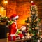 Home filled with joy and love. Cute little child boy play near christmas tree. Gifts and surprises. Merry christmas and