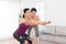 Home fitness coach teaching smiling beauty girl