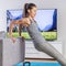 Home fitness woman exercising on living room sofa