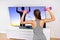 Home fitness woman strength training watching TV