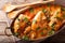 Home French chicken chasseur with mushrooms and tomatoes close-up. horizontal top view