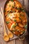 Home French chicken chasseur with mushrooms and tomatoes close-up. Vertical top view