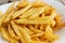 At home, french fries. close-up of finely chopped fried potatoes on white plate