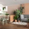 Home garden, dining and living room in white and orange tones. Island with chairs, parquet and mani houseplants. Urban jungle