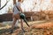 Home gardening industry - male using leaf blower during sunset