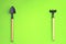 Home gardening. Miniature gardening tools on green background. Top view. seedling, cultivation. agriculture, horticulture. Copy