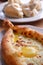 Home Georgian cuisine in a restaurant: Khachapuri Adjarian and Khinkali