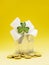 Home with glitter and white bow with green shamrock on pile of coins and yellow background. High value property cost in Ireland