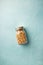 Home granola in a glass jar on blue concrete background