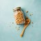 Home granola in a glass jar on blue concrete background