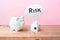 Home house mockup and piggy bank with risk text on wooden table
