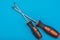 Home improvement: two screwdrivers philips and slotted on a blue flat lay background with copy space