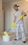 Home improvement. Young man painting ceiling