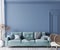 Home interior mock-up with turquoise sofa, wooden table and decor in blue classic living room