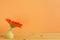 Home interior. Orange gerbera flower in vase on wooden table