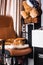 Home interior, red cat lies in an orange armchair. Beautiful cat relaxing on orange leather elegant chair at home next to an