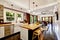 Home interior in white tones with black hardwood floor and white coffered ceiling..