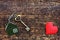 Home key with love house keyring decorate with mini heart on wood background, sweet home concept