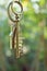 Home key with love house keyring hanging with blur garden background