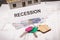 Home keys, euro and inscription recession on housing plan. House under contruction. Crisis of real estate market. Reduced housing