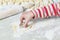 Home kitchen. On the table is a dough for baking. A child squeezes a form in it