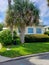 Home with large windows and tropical landscaping