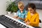 Home lesson on music for kids on the piano. The idea of activities for the child at home during quarantine. Music