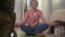 Home lifestyle - beautiful and happy mature woman with gray hair on her 50s doing yoga and meditation exercise