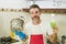 Home lifestyle portrait of happy and attractive man in red apron smiling at kitchen washing dishes and cooking pot cheerful doing