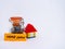 Home loan concept shown with a lego house toy and glass jar full of coins against white background