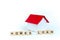 Home loans- word composed fromwooden blocks letters on White background, layout of a house with a red roof. copy space